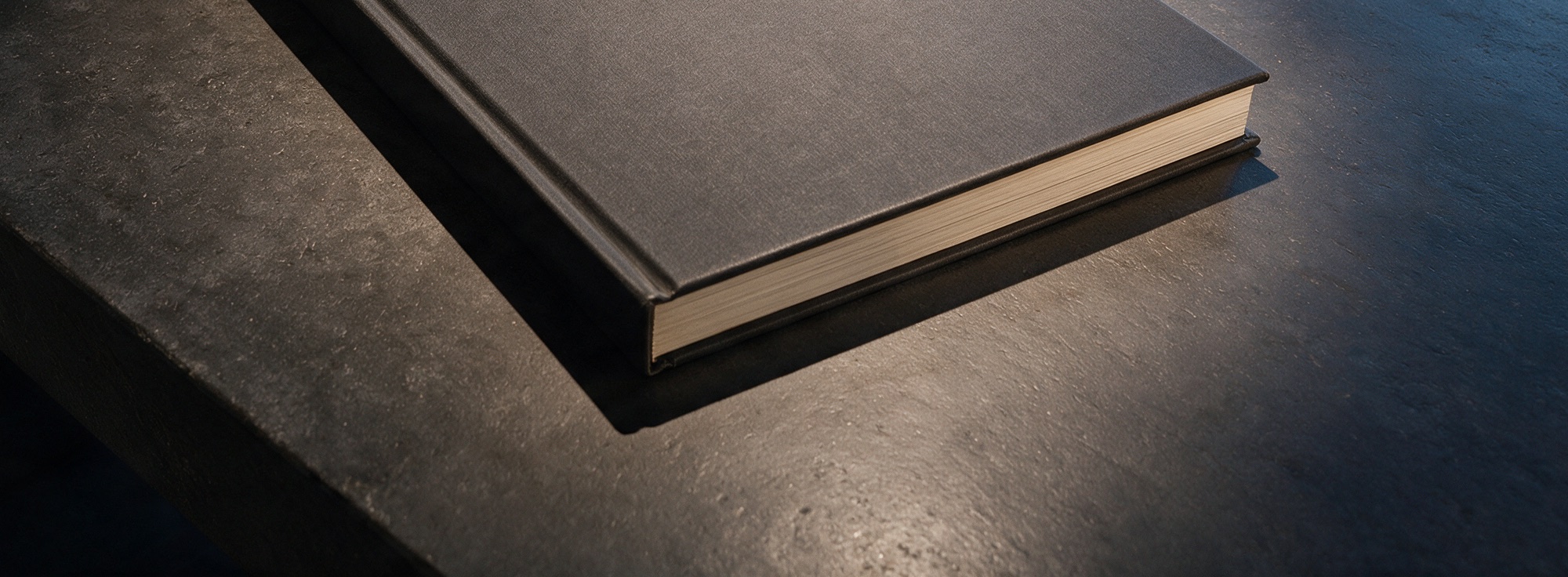 The London Edit catalogue, closed, on a dark stone table